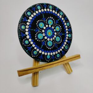 Blue dot mandala with white details on black background