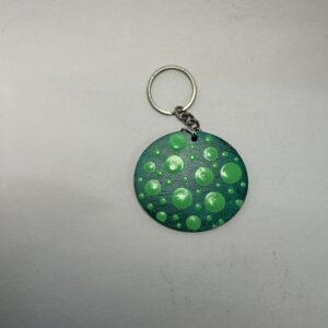 Hand-painted green dot mandala keychain on MDF